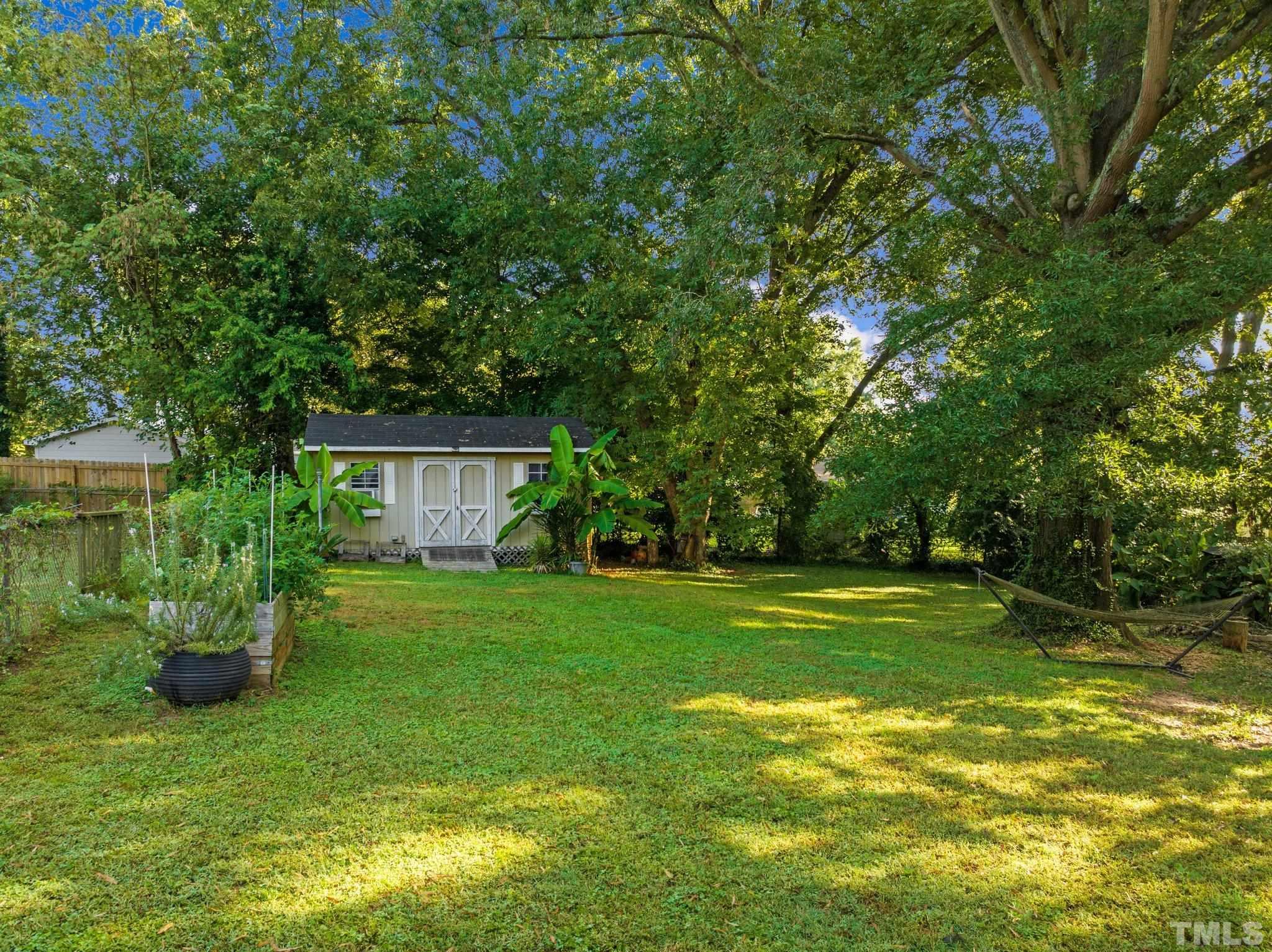 2615 Layden Street Raleigh, NC 27603 - Photo 27 of 34 a view of a house with a big yard and a large tree