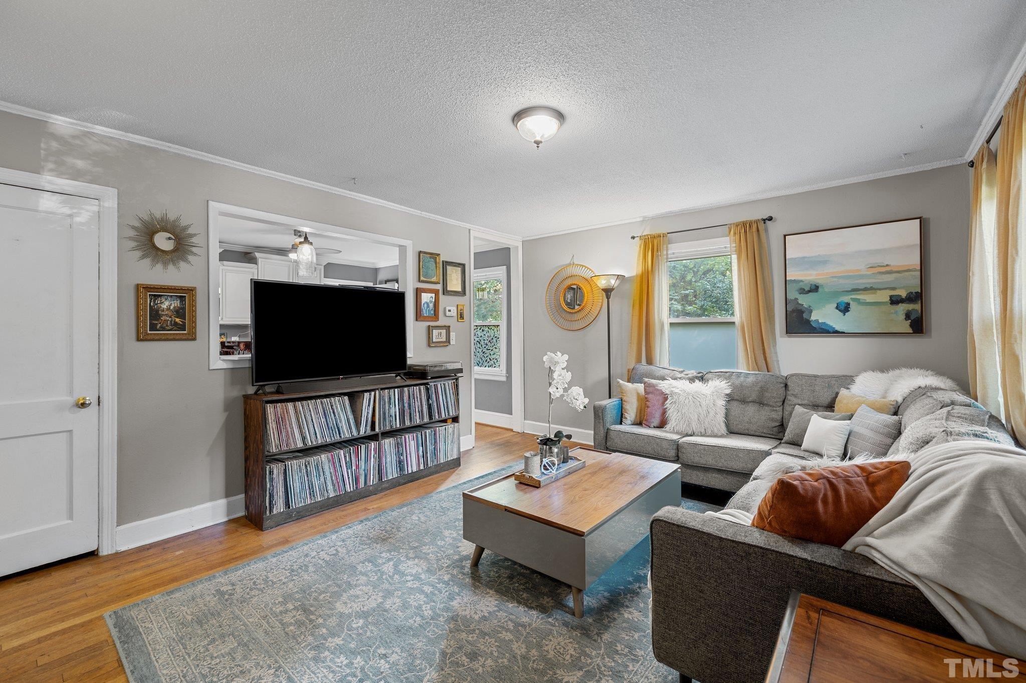 2615 Layden Street Raleigh, NC 27603 - Photo 4 of 34 a living room with furniture and a flat screen tv