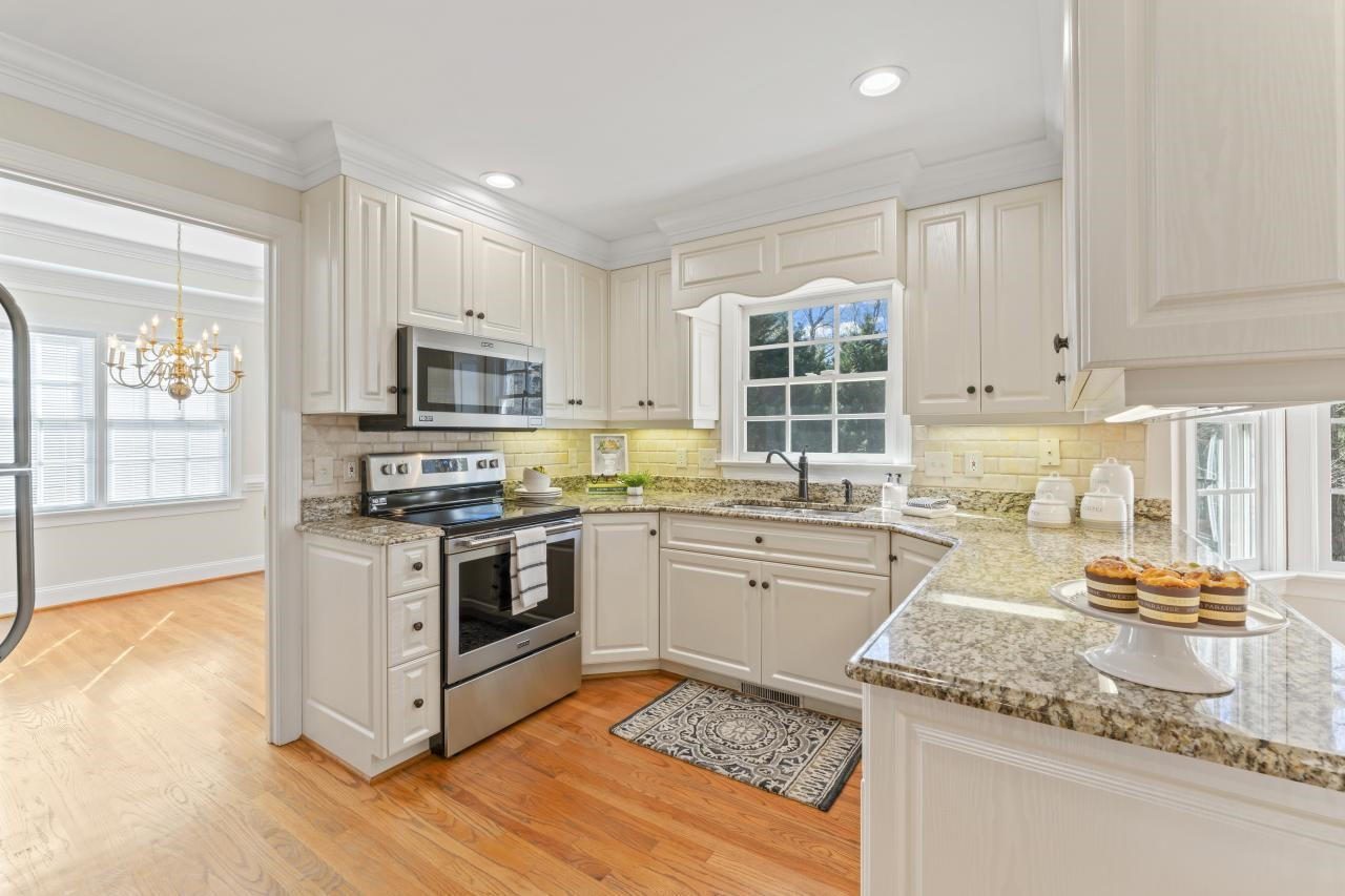 5013 Trail Ridge Drive Raleigh, NC 27613 - Photo 9 of 32 Granite countertops and a beautiful view of your large backyard make this a kitchen you'll want to be in. Kitchen
