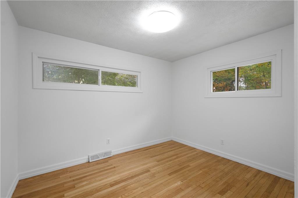 186 Gretna Road Washington, PA 15301 - Photo 22 of 48 a view of an empty room with wooden floor and a window