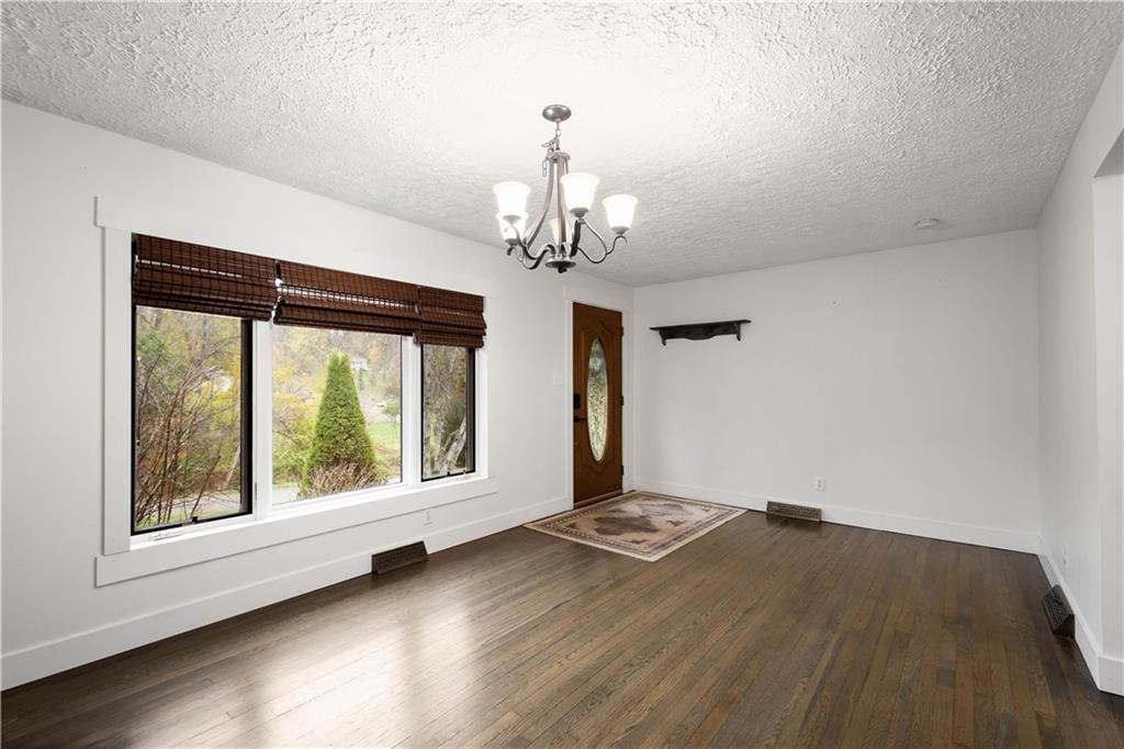 186 Gretna Road Washington, PA 15301 - Photo 4 of 48 a view of a big room with wooden floor chandelier and windows