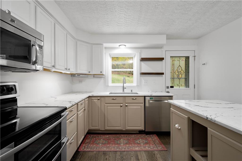 186 Gretna Road Washington, PA 15301 - Photo 5 of 48 a kitchen with a sink stove top oven and cabinets