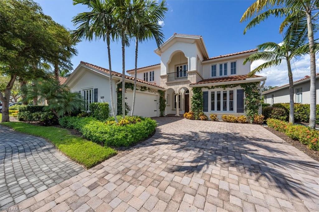 2139 Torino Way Naples, FL 34105 - Photo 1 of 24 a front view of a house with garden and trees