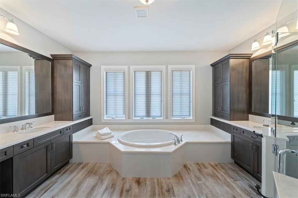 2139 Torino Way Naples, FL 34105 - Photo 13 of 24 a bathroom with a bathtub double sink mirror and a shower