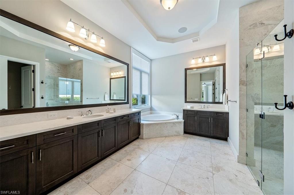 2139 Torino Way Naples, FL 34105 - Photo 15 of 24 a spacious bathroom with a tub sink shower and mirror