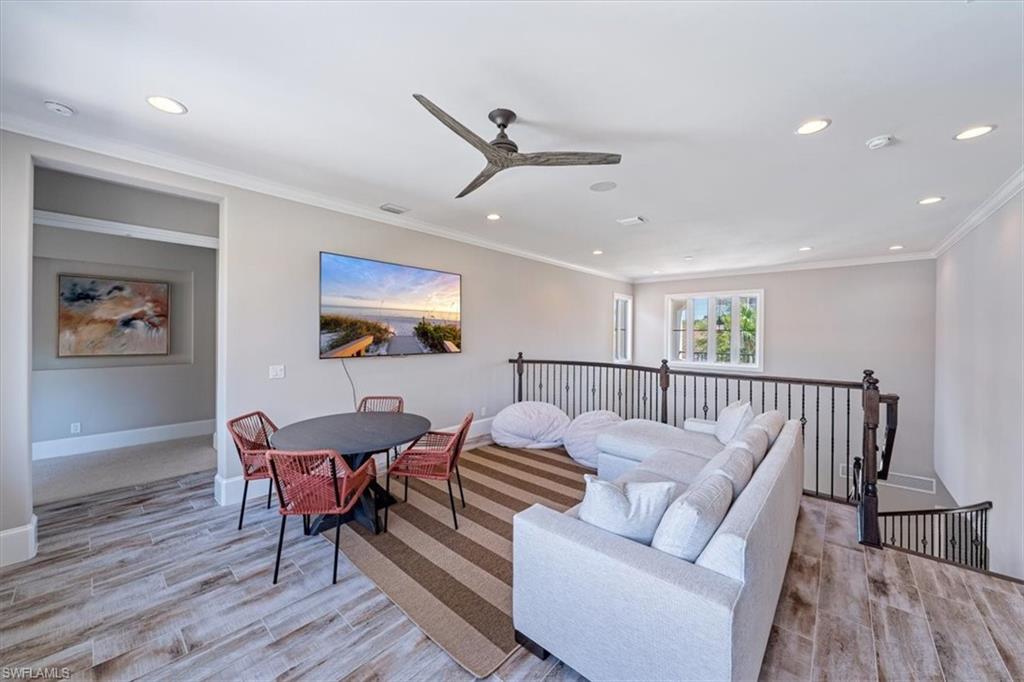 2139 Torino Way Naples, FL 34105 - Photo 16 of 24 a living room with furniture and a wooden floor