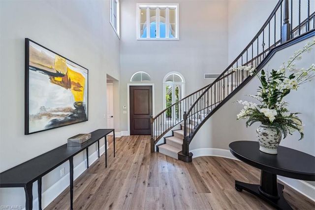 a view of entryway with wooden floor and stairs
