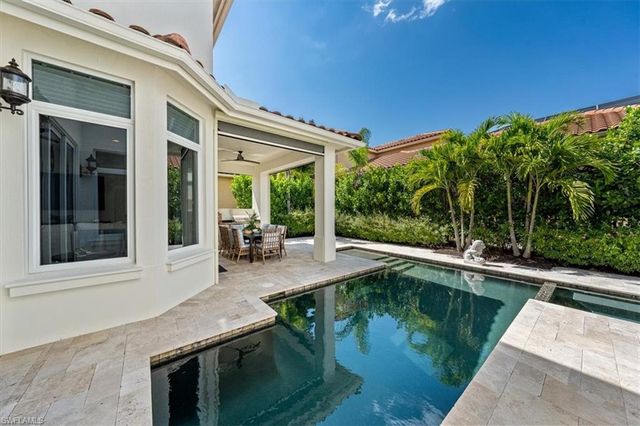 a swimming pool with outdoor seating and yard