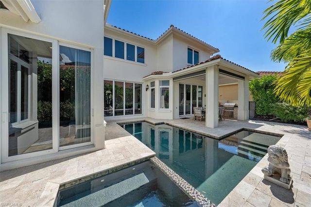 a view of house with a swimming pool