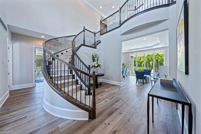 a view of entryway livingroom and hall with wooden floor