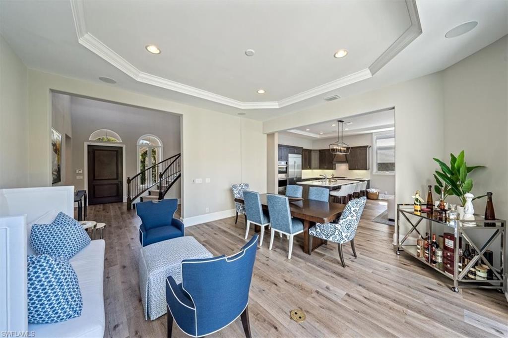 2139 Torino Way Naples, FL 34105 - Photo 5 of 24 a living room with furniture a wooden floor and a potted plant