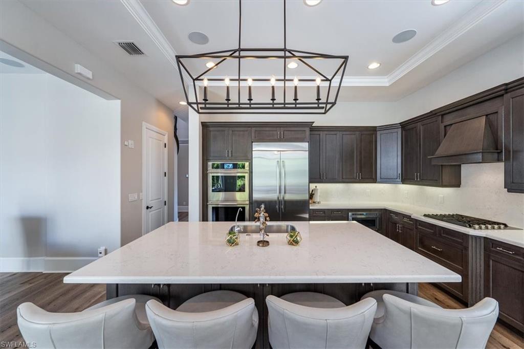 2139 Torino Way Naples, FL 34105 - Photo 6 of 24 a view of a dining room with furniture and a chandelier