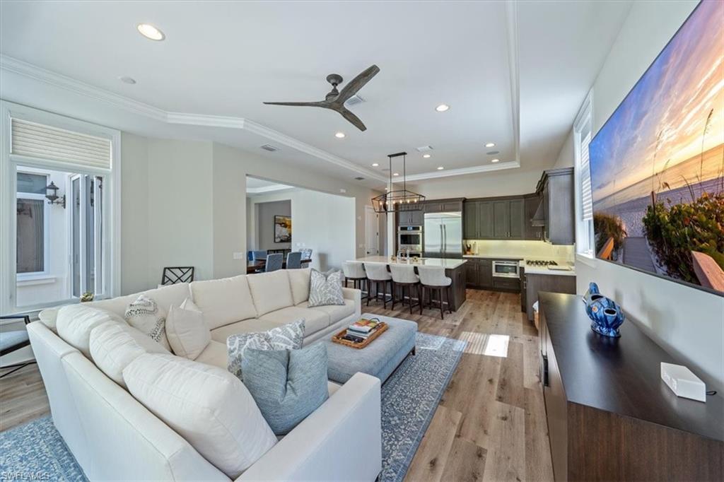 2139 Torino Way Naples, FL 34105 - Photo 8 of 24 a living room with furniture kitchen view and a large window