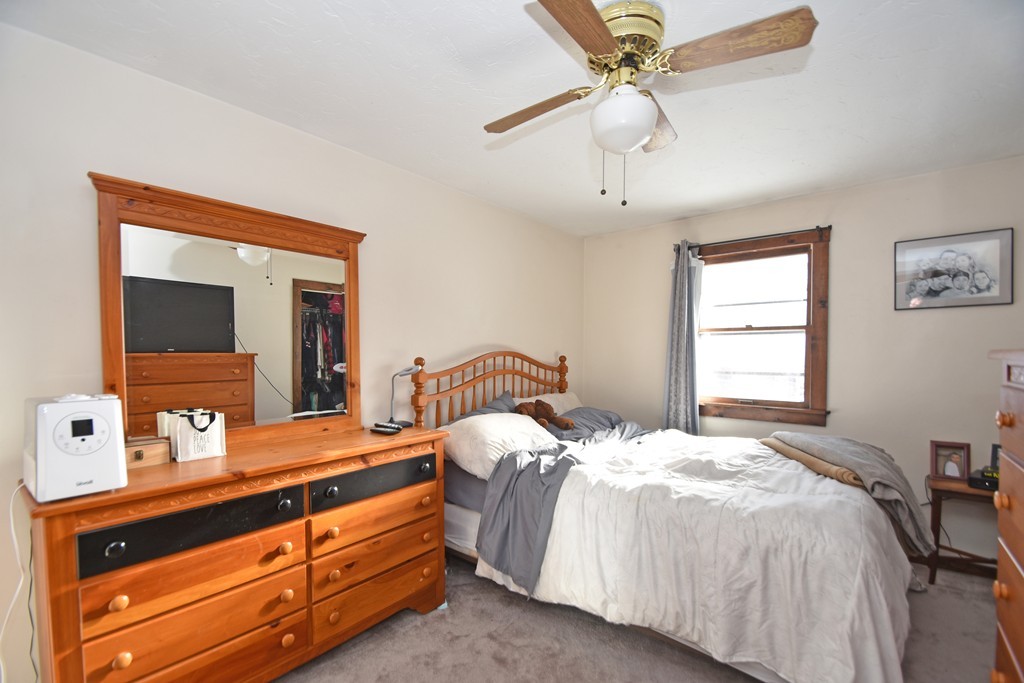 46 Davis Road, Unit B Millbury, MA 01527 - Photo 11 of 18 a bedroom with a bed and a flat tv screen on dresser