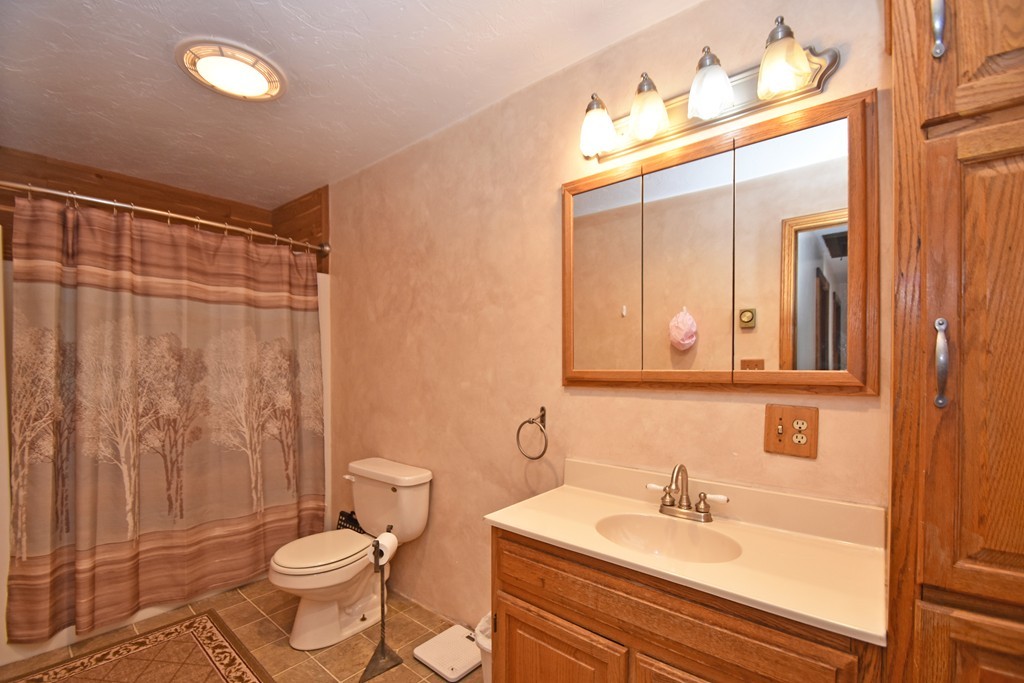 46 Davis Road, Unit B Millbury, MA 01527 - Photo 12 of 18 a bathroom with a sink a toilet and shower