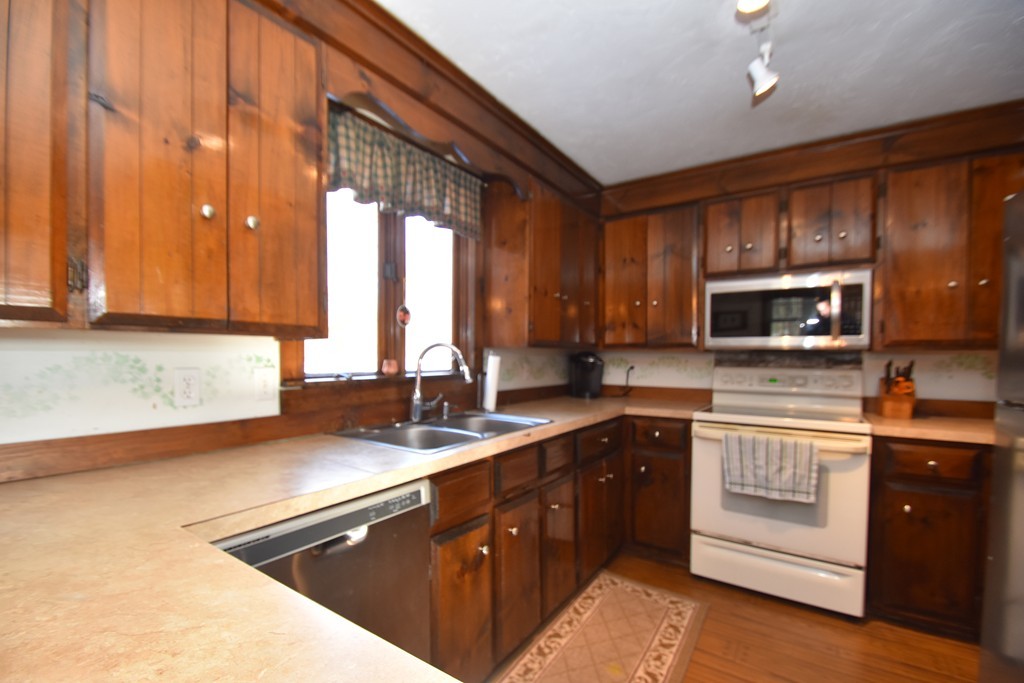 46 Davis Road, Unit B Millbury, MA 01527 - Photo 4 of 18 a kitchen with a sink stove and microwave