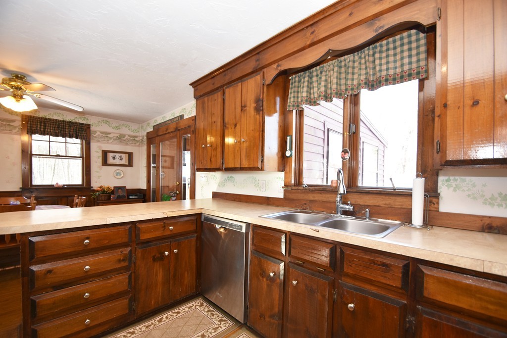 46 Davis Road, Unit B Millbury, MA 01527 - Photo 5 of 18 a kitchen with a sink a window and cabinets