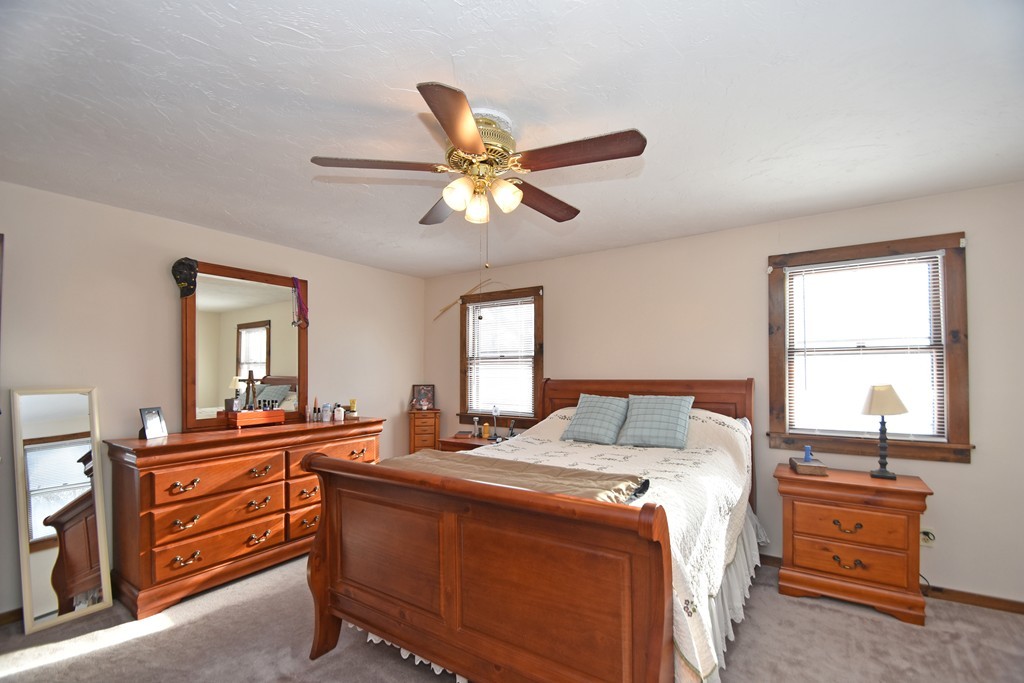 46 Davis Road, Unit B Millbury, MA 01527 - Photo 9 of 18 a bed room with a bed and a chandelier