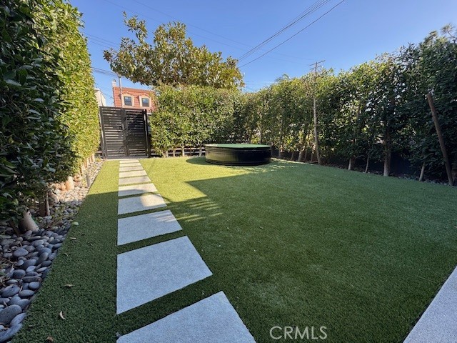 335 Flint Avenue Long Beach, CA 90814 - Photo 3 of 46 a view of yard with swimming pool and trees in the background