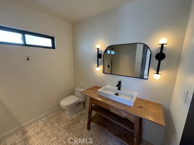 335 Flint Avenue Long Beach, CA 90814 - Photo 40 of 46 a bathroom with a toilet sink and mirror