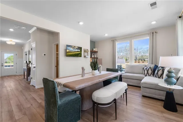 a living room with furniture a wooden floor and a table