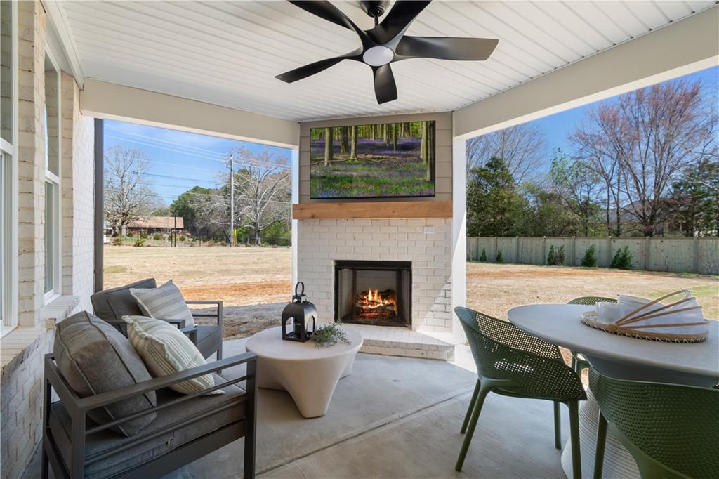 420 Hartsfield Road McDonough, GA 30252 - Photo 14 of 45 a living room with furniture a fireplace and a floor to ceiling window