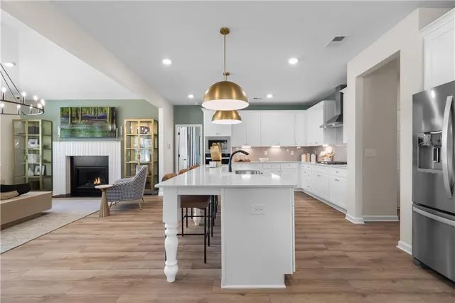 a kitchen with granite countertop a stove oven and a fireplace