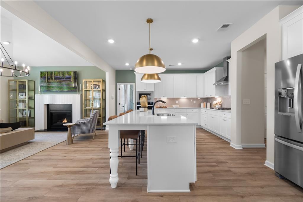 420 Hartsfield Road McDonough, GA 30252 - Photo 16 of 45 a kitchen with granite countertop a stove oven and a fireplace