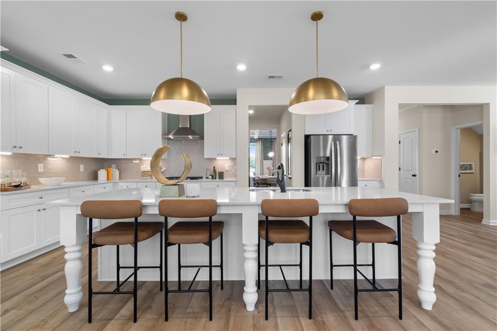420 Hartsfield Road McDonough, GA 30252 - Photo 18 of 45 a dining room with furniture and wooden floor