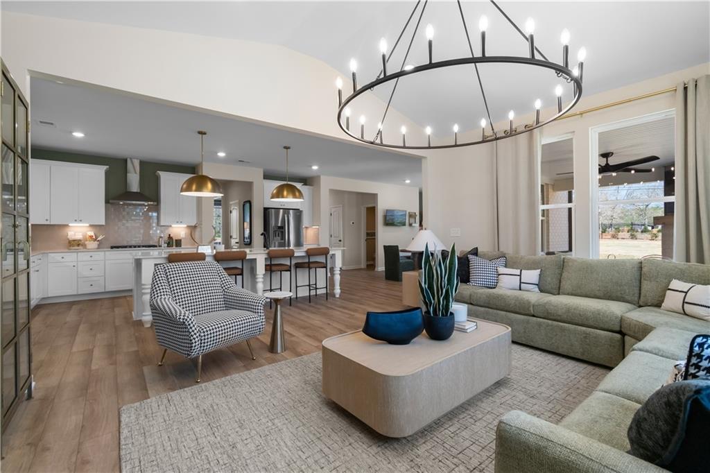 420 Hartsfield Road McDonough, GA 30252 - Photo 22 of 45 a living room with furniture a chandelier and kitchen view