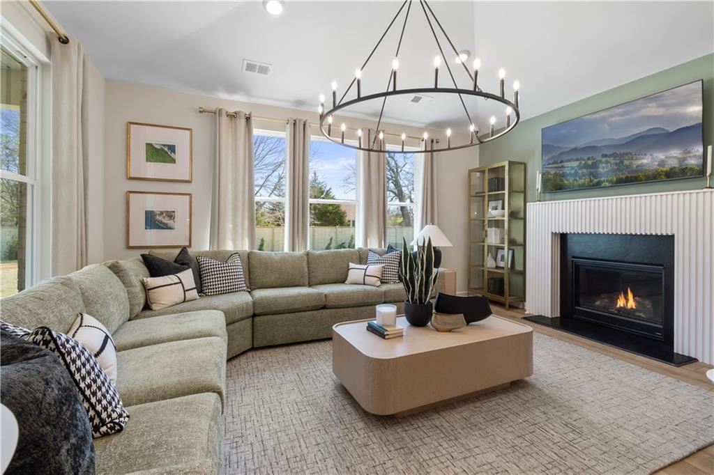 420 Hartsfield Road McDonough, GA 30252 - Photo 23 of 45 a living room with furniture a fireplace and a large window