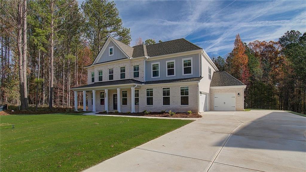 420 Hartsfield Road McDonough, GA 30252 - Photo 3 of 45 a front view of a house with a garden and trees