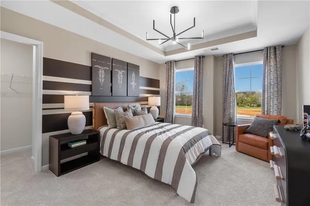 a bedroom with a bed couches and wooden floor