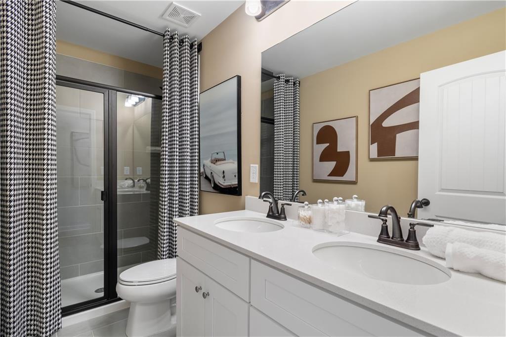 420 Hartsfield Road McDonough, GA 30252 - Photo 33 of 45 a bathroom with a toilet a sink and mirror