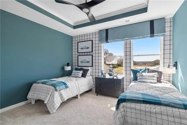 a bedroom with a bed couch and a large window