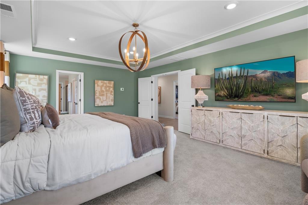 420 Hartsfield Road McDonough, GA 30252 - Photo 38 of 45 a spacious bedroom with a bed and a large mirror on the dresser