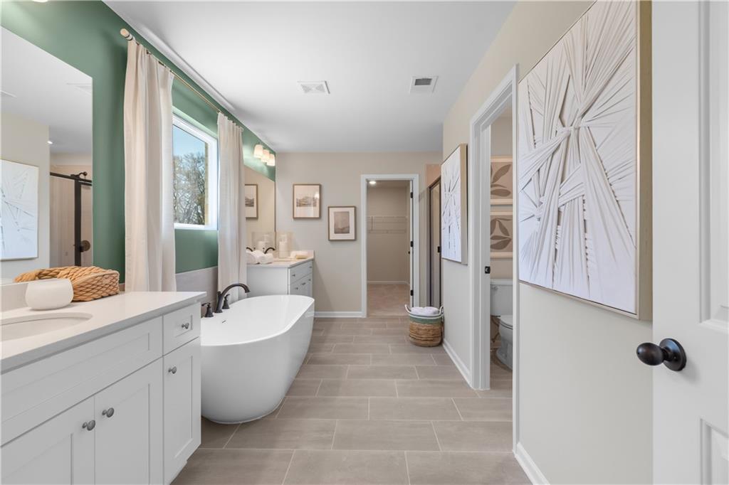 420 Hartsfield Road McDonough, GA 30252 - Photo 40 of 45 a large spacious bathroom with a bathtub and sink