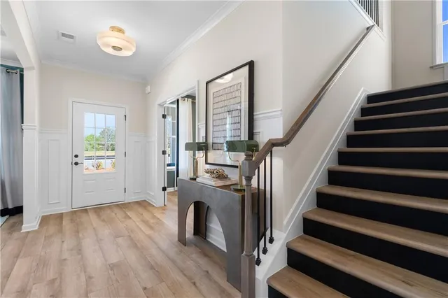 a view of entryway with wooden floor and stairs