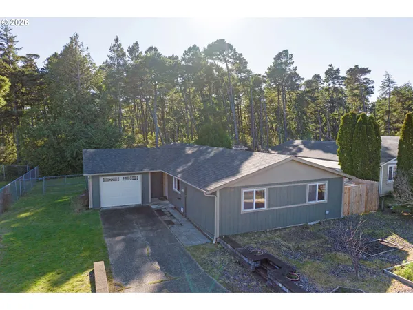 a aerial view of a house next to a yard