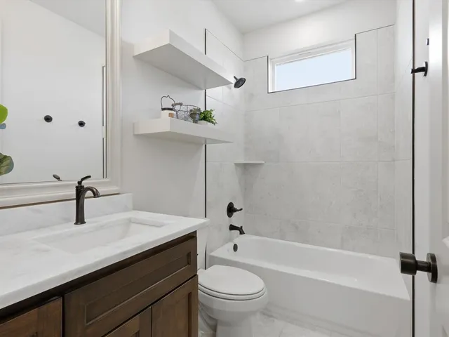 a bathroom with a sink a toilet and a bathtub