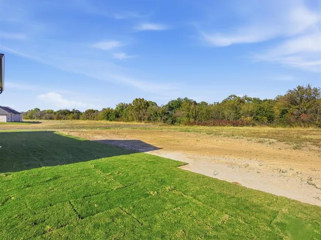 a view of a lake with houses in the background