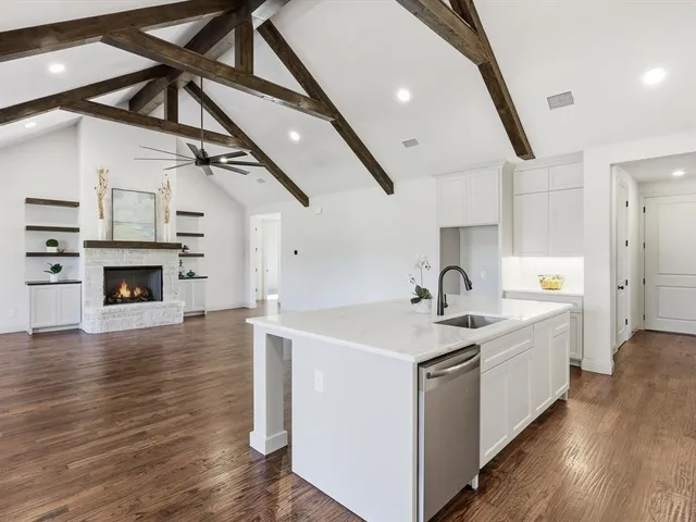 a view of a kitchen with sink and wooden floor