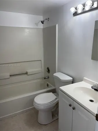a bathroom with a toilet a sink and bathtub