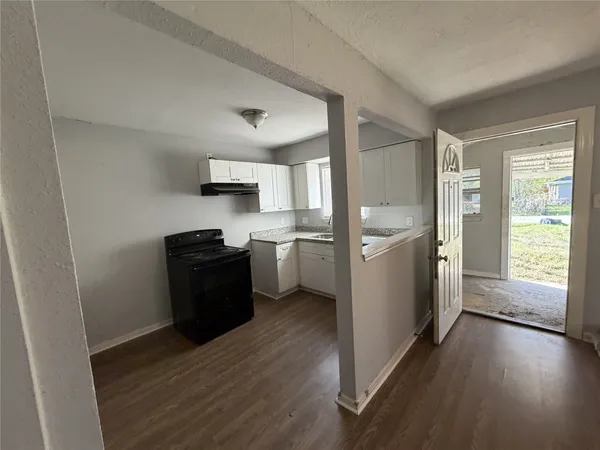 a kitchen with a refrigerator and a stove top oven