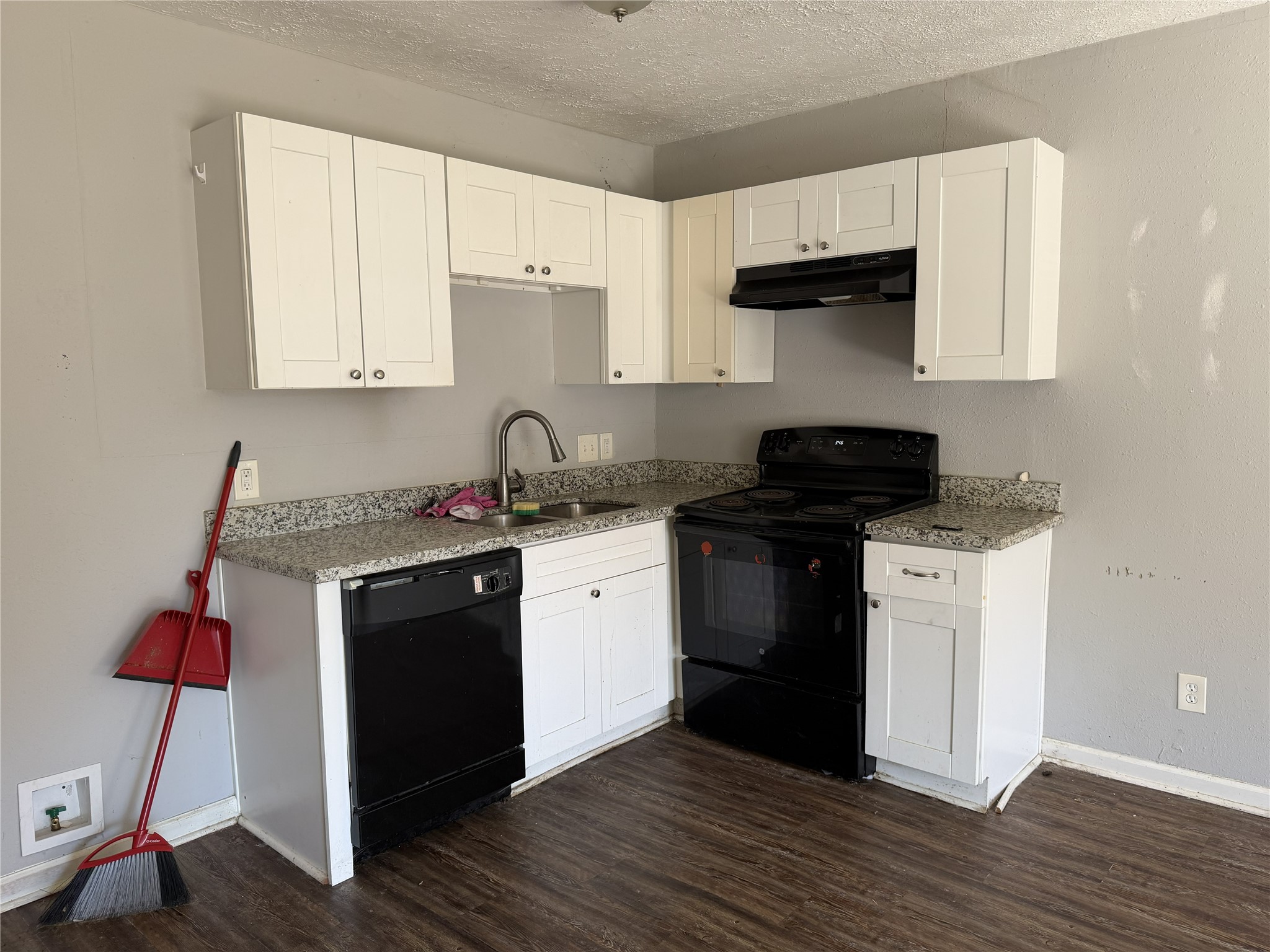 2409 Hodges Street Baytown, TX 77521 - Photo 15 of 29 a kitchen with a sink and a stove top oven