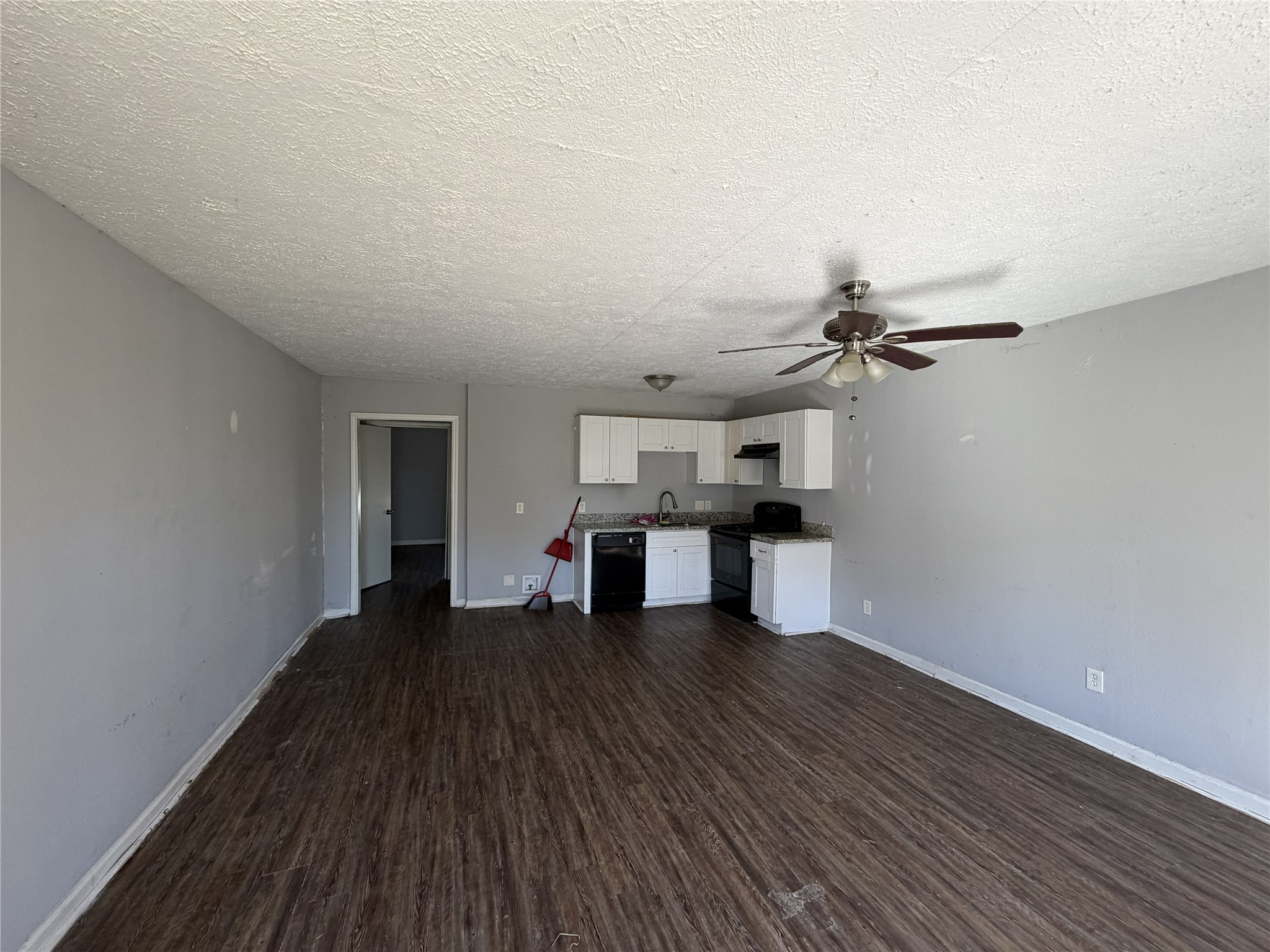 2409 Hodges Street Baytown, TX 77521 - Photo 3 of 29 a view of a room with wooden floor and a ceiling fan