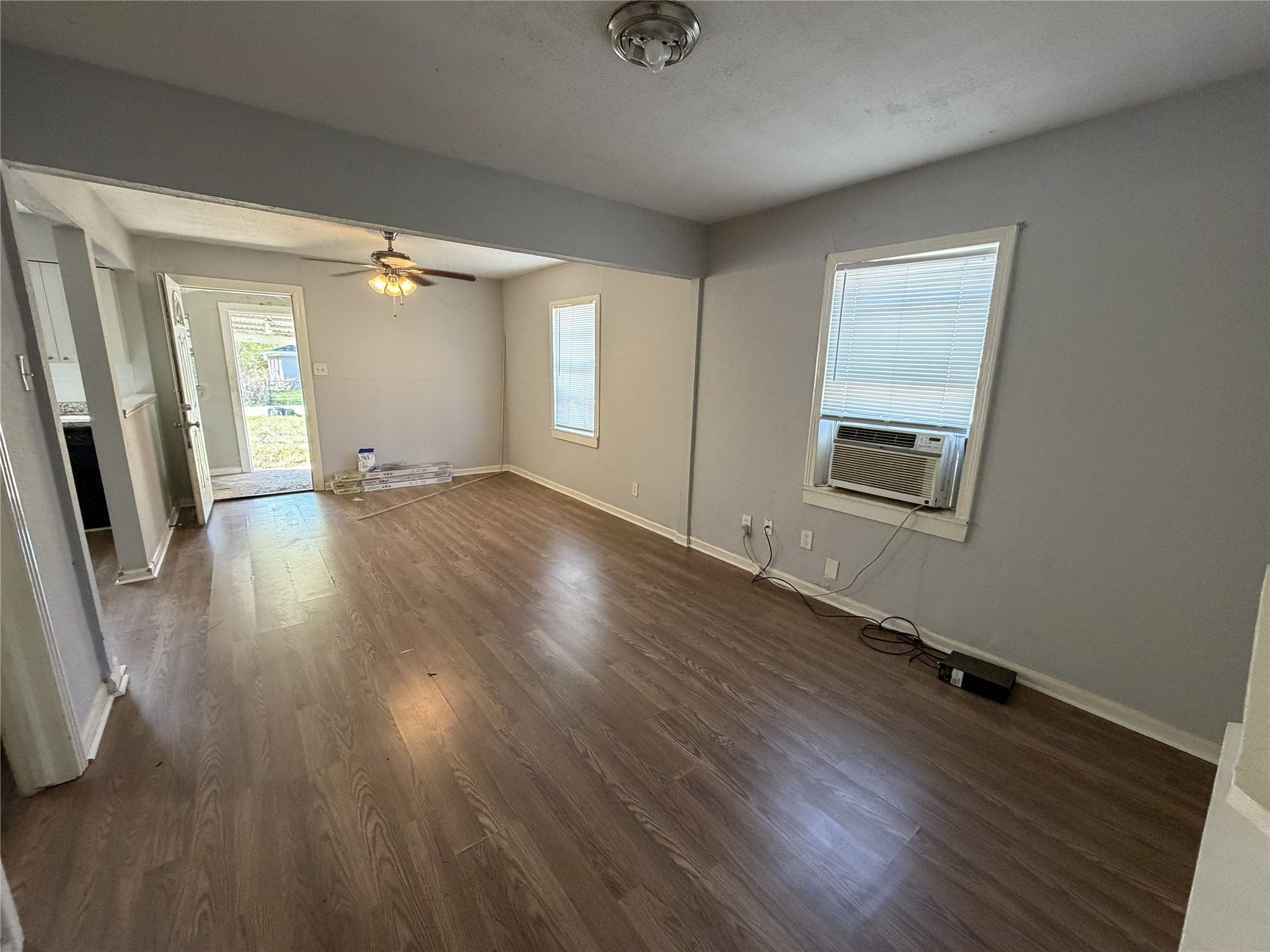 2409 Hodges Street Baytown, TX 77521 - Photo 5 of 29 an empty room with wooden floor and windows