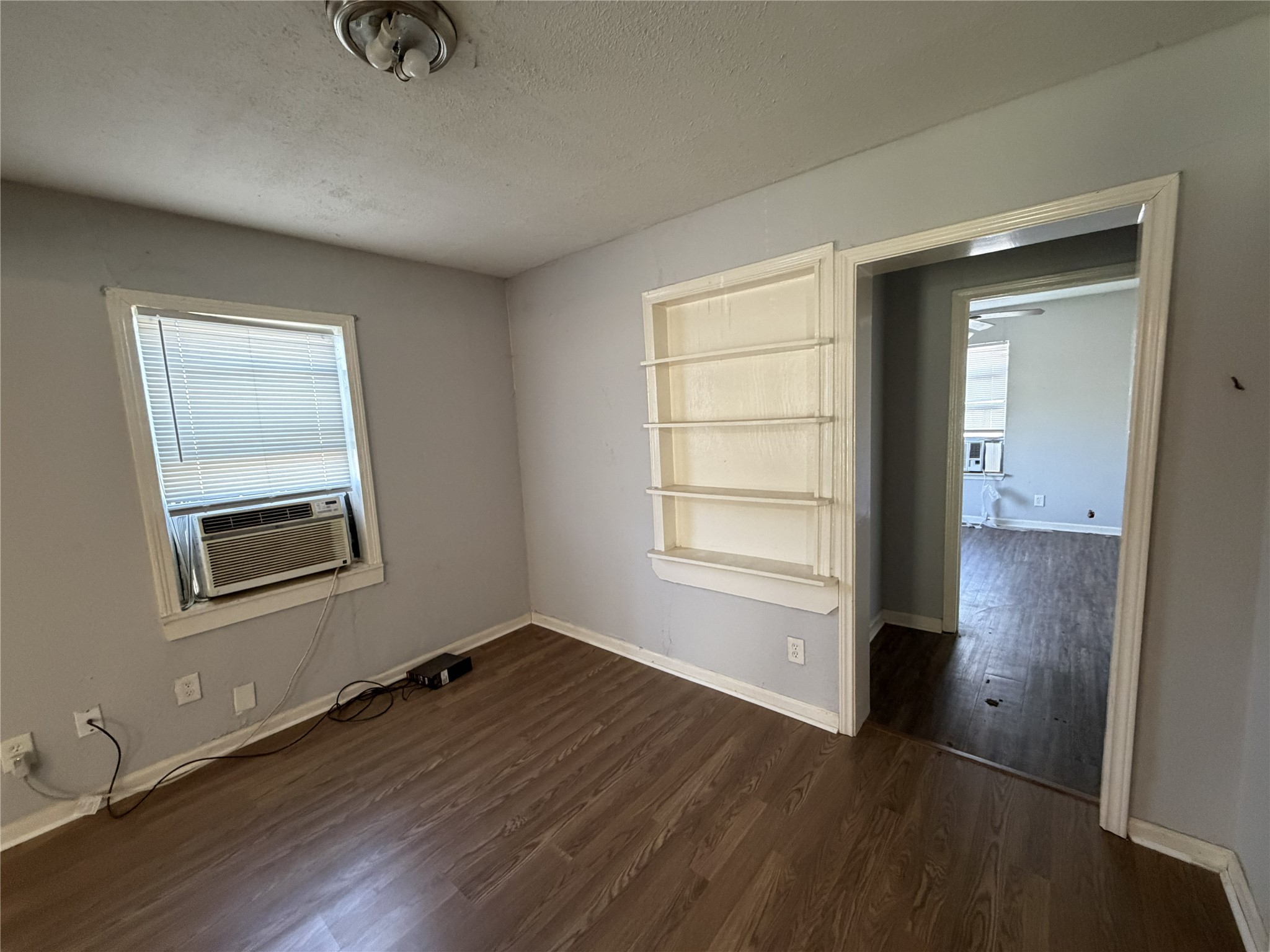 2409 Hodges Street Baytown, TX 77521 - Photo 7 of 29 wooden floor in an empty room with a window