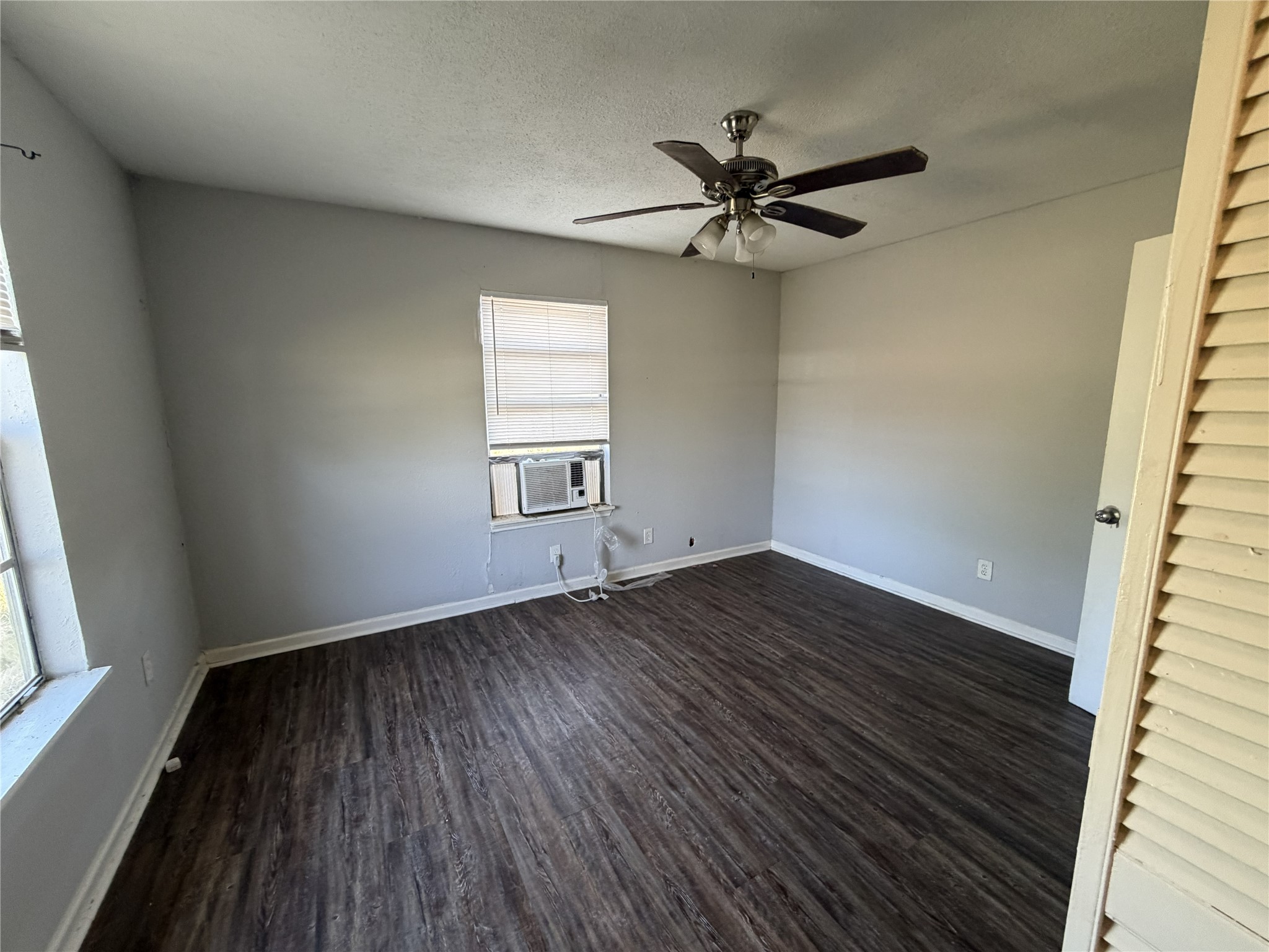 2409 Hodges Street Baytown, TX 77521 - Photo 9 of 29 wooden floor in an empty room with a window