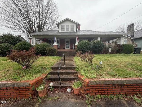 a front view of a house with a yard table and chairs